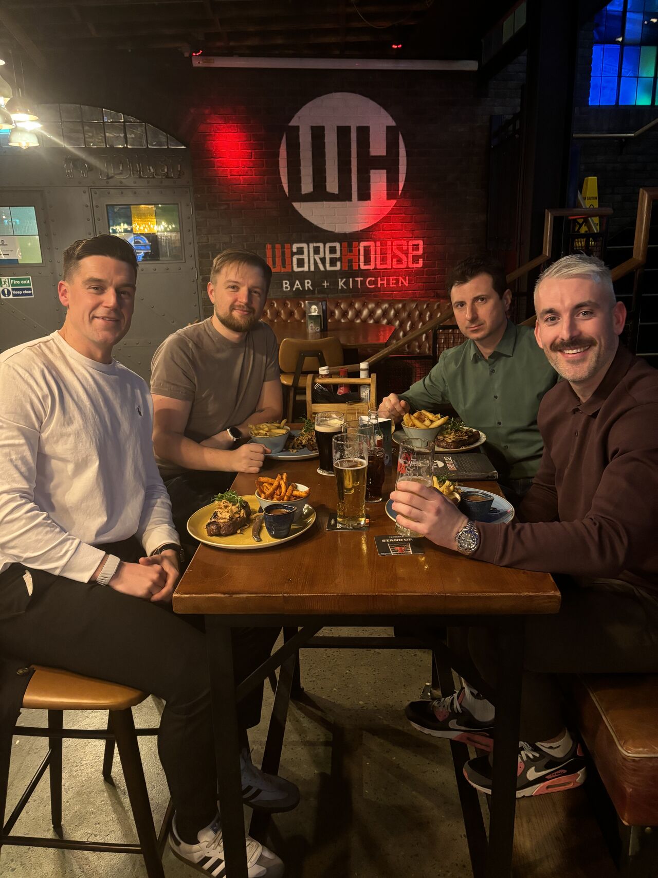 Four of the Inspire Medical team round a restaurant table during a run of hospital visits