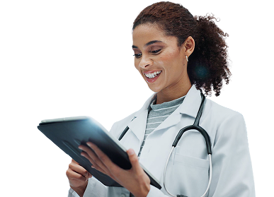 A doctor in a white coat smiling at the tablet in her hands